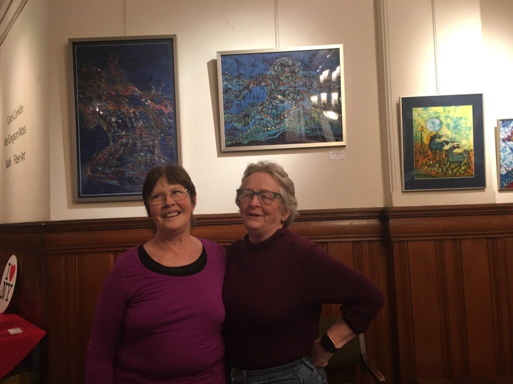 Carol Law Conklin and Kris Gregson Moss in front of their artwork